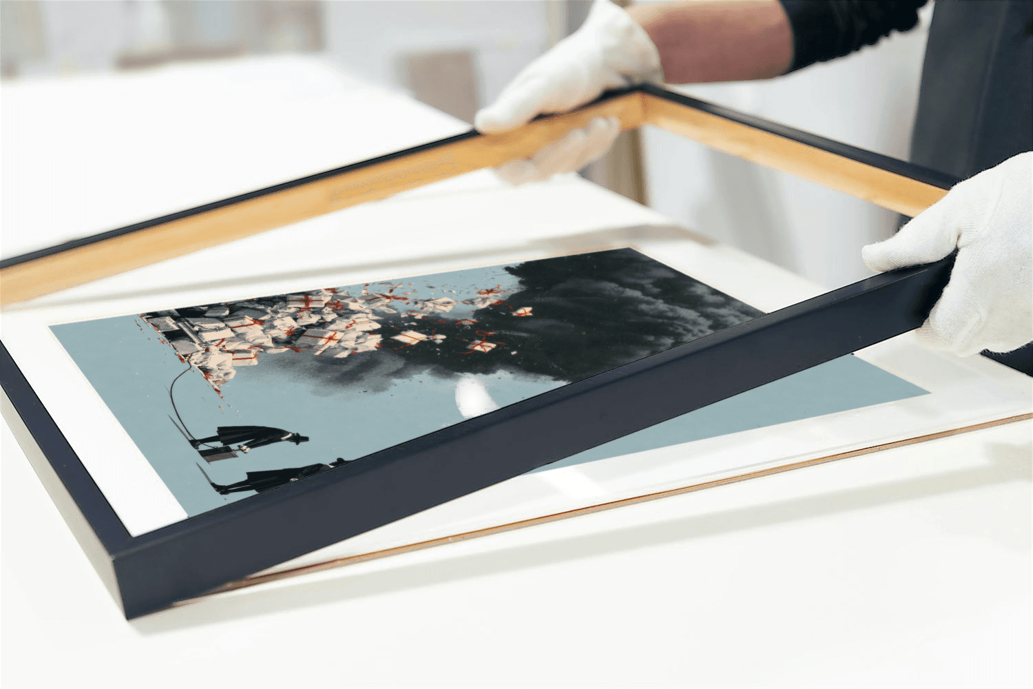 White-gloved hands fitting a black frame around the mounted Pilgrim print